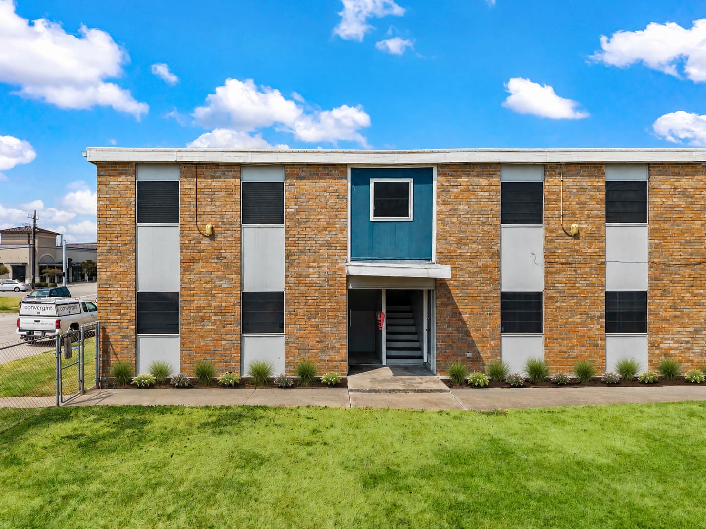 Brick apartment exterior and lawn at 3rd Coast Apartments in Galveston